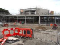 The new station building at the north end of the up platform at Wakefield Westgate seen taking shape on 13 August 2013. view looking across to the main entrance, with the wide stairway running up to the new footbridge visible to the right of the atrium section. <br><br>[David Pesterfield 13/08/2013]