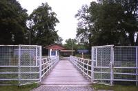 The photographer is in the German town of Ostritz, but the latter's station (at the other end of the footbridge) is in Poland. Polish freight wagons are in evidence here on 5th July 2013 on the Goerlitz-Zittau line, which crosses and recrosses the border on several occasions and has two intermediate junctions within Poland taking freight traffic to Mikulasovice and Bogatynia (formerly Reichenau).<br><br>[David Spaven 05/07/2013]