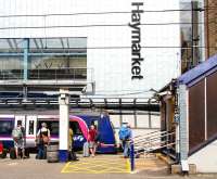 The east end of Haymarket station on 9 August 2013. Passengers at platform 2 are awaiting the 12.32 to Inverurie, while the 11.28 Dunblane - Edinburgh Waverley has just pulled into platform 1.<br><br>[John Furnevel 09/08/2013]