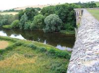 <I>The Great Escape - Roxburgh Viaduct 2013</I>... not quite! Attempts to recreate the 1968 BMcC photograph [see image 17963] were thwarted due to vegetation now blocking the view from the other end of the viaduct. This version looks east over the Teviot towards Kelso. Just north of here is a famous junction - nothing to do with railways, but much loved by salmon fishermen. Note the pedestrian footbridge now strapped to the north side of the structure down below.   <br><br>[John Furnevel 13/08/2013]