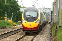 A southbound Pendolino has just passed Balshaw Lane Junction on 23 June 2013. The train is speeding south towards its next stop at Wigan North Western. Another Pendolino can be seen heading north in the background.<br><br>[John McIntyre 23/06/2013]