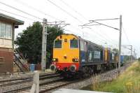 One quarter of the DRS Class 20 fleet passes Hest Bank level crossing on a Sellafield to Crewe working on 17 August, comprising a single wagon. 20312 (VF 1959) and 20302 (RSH 1961) are from the same era as the doomed Hest Bank box (1958) but hopefully the locos still have further useful life ahead of them.<br><br>[Mark Bartlett 17/08/2013]