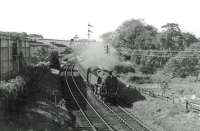 80110 approaches Thornliebank with the 17.33 from St Enoch to East Kilbride in June 1963. The distant signal above the engine was for Thornliebank box which was always 'switched out' until closure in 1964. The Argus foundry is in the left background with Eastwood box just visible through the smoke. <br><br>[John Robin 13/06/1963]