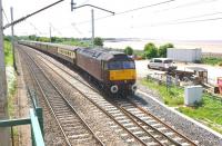 The ecs from the Compass tours special from North Berwick to Morecambe on 15 June 2013 is hauled back for servicing at Carnforth by 47786. The train is joining the WCML off the Bare Lane route at Hest Bank. To the right are the sands of Morecambe Bay and on the horizon above the van in the yard is the town of Morecambe itself. [See image 43442]<br><br>[John McIntyre 15/06/2013]