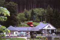 The Oberweissbacher Bergbahn's standard-gauge passenger coach (carried piggyback on a 1.8m gauge Rollwagen) inches down into the Obstfelderschmiede terminus on 29th June 2013. Passengers interchange here with the standard-gauge Schwartzatalbahn branch line, whose single-track platform runs left to right in the foreground.<br><br>[David Spaven 29/06/2013]