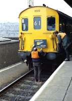 <I>Down a bit...</I> The headboard of the <I>Gunnislake Goliath</I> is adjusted at Plymouth station on 21 December 1985. The special, organised by Hertfordshire Railtours, ran from London and visited Plymstock, Saltash and the Gunnislake branch. The tour was handled throughout by DEMU 1032.<br><br>[Ian Dinmore 21/12/1985]