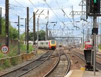 <I>Please form an orderly queue...</I> The late running Virgin Trains 08.20 ex Birmingham New Street gets the road from Haymarket East Junction into platform 3 on 9 August 2013. Meantime the 10.57 Milngavie - Waverley service waits patiently in the background to access the same platform.   <br><br>[John Furnevel 09/08/2013]