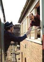 Mike Hayman, the signalman at Cowley Bridge Junction, takes the token from a passing train in the summer of 1985.<br><br>[Ian Dinmore //1985]