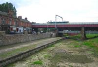 Looking west along the Monkland Canal basin at Coatbridge on a grey August afternoon in 2006. A class 90 is taking a northbound train of container flats across the bridge towards Coatbridge Central, just off picture to the right. The train is heading for Coatbridge Freightliner Terminal, a short distance to the north of the station on Gartsherrie Road.<br><br>[John Furnevel 31/08/2006]