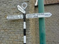 The repainted road sign directs motorists to Harome Sidings on the Pickering to Gilling line in August 2013. Harome did not have a station, only a single line railway, with a 41 yard siding, which last saw use about  55 years ago. The line was closed completely in May 1964 and the track lifted in 1965.<br><br>[Vic Smith 08/08/2013]