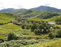 Black 5 No 45407 brings the morning <I>Jacobite</I> round the curve at Arieniskill near Lochailort on 22 August. On the right is Lochan Dubh and the prominent peak in the background is Beinn Coire nan Gall.<br>
<br><br>[John Gray 22/08/2013]