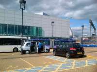 I'm sure this station is very efficient; but it's hardly elegant. A train can just be seen above the parked car.<br><br>[Ken Strachan 09/08/2013]