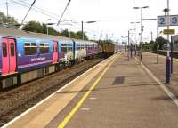 Looking south at Harlington, Bedfordshire, on 1 September as First Capital Connect Class 319smeet on services between St Pancras and Bedford. Platforms 1 & 2 are on the slow lines, normally used by FCC services, whilst over on platforms 3 & 4 the non stop EMT services rush pass.<br><br>[John McIntyre 01/09/2013]