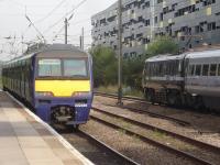 Northern 322485 is leaving on the 09.54 to Leeds whilst 91113, still awaiting a repaint into silver grey livery, readies to propel the 09.56 East Coast service forward to Kings Cross. The large new shared station and general use car park can be seen to the upper right.<br><br>[David Pesterfield 04/09/2013]