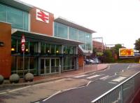 The old station building at Rugby contrasts with the new entrance, which is particularly convenient for platform 1 (left). The concrete spheres by the kerb could be borrowed from somewhere, but make surprisingly comfortable seats.<br><br>[Ken Strachan 08/08/2013]