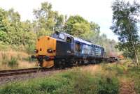 DRS 37608 and 37218 run south past what remains of The Mound station with a nuclear flask special on 3 September 2013. Once the junction for the Dornoch Branch, time has taken its toll here and the area is now heavily overgrown. The former station building still stands as a private residence.<br><br>[John Gray 03/09/2013]