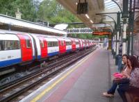 In case of delays, always carry a 'phone. At least one of these ladies is waiting patiently for a Northern line train into London at High Barnet platform 2 on 5th August.<br><br>[Ken Strachan 05/08/2013]