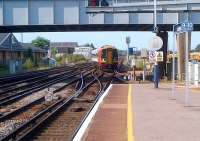 The 16.24 Basingstoke - Portsmouth Harbour snakes across to platform 3 on the northern approach to Eastleigh station on 1st August 2013. The line to the left passes through Chandlers Ford to Romsey [see image 34131], and was reopened to passengers in the late 1980's if I recall correctly.<br><br>[Ken Strachan 01/08/2013]