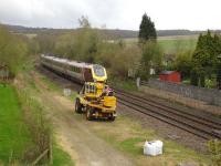 A CrossCountry 220 Voyager heads south passing Crigglestone West station site, heading for Woolley tunnel and Barnsley, during a series of week-end closures of the normal route between Wakefield Westgate and Sheffield via Moorthorpe<br><br>[David Pesterfield 28/04/2013]
