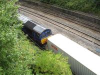 Grab shot showing ex DRS operated, former Malcolm liveried, 66412 running along the Crewe station avoiding line, just after it exits the underpass below the main line. The train is a Freightliner intermodal working from Manchester. <br><br>[David Pesterfield 30/08/2013]