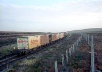 The <I>Safeway</I> container train approaching County March Summit on its way north in February 2002 behind an EWS Class 66 locomotive.<br><br>[Ewan Crawford /02/2002]