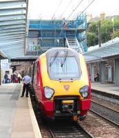 Not far now! The Virgin Trains 08.20 Birmingham New Street - Edinburgh Waverley about to undertake the short final leg of its journey at Haymarket platform 3 on 9 August. Work on the transformation of Haymarket station is in full swing in the background.<br><br>[John Furnevel 09/08/2013]