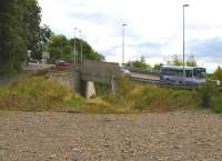 Looking south east towards Tweedbank from the site of the planned Galashiels station on 18 September 2013. The modern road bridge which carries the B6374 Station Brae over the rail route was completed in 2007. A no 7 bus heading for Galashiels bus station is approaching with a local service from Langlee.<br><br>[John Furnevel 18/09/2013]