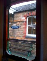 Aha! So this side is Sible and Castle Hedingham - it must be the other side that is Halstead. [see image 44123] Station sign and bench framed in a 'bubble car' window during a BLS visit.  <br><br>[Ken Strachan 20/07/2013]