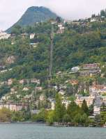 The Territet Funicular runs from Territet, a suburb of Montreux, on the shore of Lake Geneva up to Glion. Here it meets the Rochers de Naye rack railway, which can also be seen climbing across the hillside from the viaduct on the left of the picture. [See image 45142] for the view from above.<br><br>[Mark Bartlett 08/09/2013]