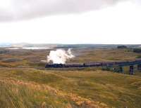 The rails are wet and the sanders are working as K4 No.61994 <I>The Great Marquess</I> gets to grips with the gradient north of Rannoch Station hauling the heavily laden <I>West Highlander</I> Railtour on 22 September. In the background is Loch Eigheach or Gaur Reservoir and in the far distance on the extreme left is the summit of Schiehallion.<br><br>[John Gray 22/09/2013]