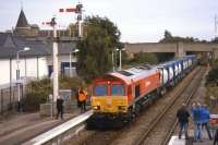 DBS 66097 brings a train of empty whisky tanks and containers into Elgin Up Loop on 13thSeptember 2013, prior to propelling back into Elgin Yard. The movement was in connection with the next day's inaugural loaded train to Grangemouth as part of the EU-funded<I>Lifting the Spirit</I>project.<br><br>[David Spaven 13/09/2013]