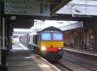 DRS 66421 is clearly focussed on the task ahead as it bustles North through Nuneaton platform 2 on 31 July 2013 hauling W.H.Malcolm container traffic.<br><br>[Ken Strachan 31/07/2013]