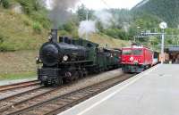 <I>Swiss Fellsman?</I> Rhaetian Railways operate the metre gauge network in south east Switzerland. It is mainly electric but they have some diesels and also preserved steam on their books. RhB electric 605 <I>Silvretta</I>, a mere 60 years old, has just run round the Davos portion of the <I>Glacier Express</I> at the junction at Filisur but is held briefly while RhB 108 <I>Engiadana</I>, a splendid looking 2-8-0 dating from 1906, departs for Chur with a well loaded special excursion. 108 and sister 107 were retained for snowplough duties long after 27 other class members were sold to Siam and Brazil.<br><br>[Mark Bartlett 14/09/2013]