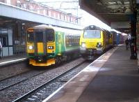 153354 may not be a beauty, but 70008 is certainly a beast. Contrasting front ends at platforms 1 and 2 at Nuneaton on 31 July. Both trains were heading for Coventry - the freight first.<br><br>[Ken Strachan 31/07/2013]