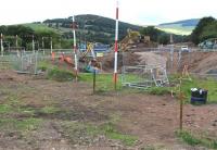 Looking north west in the general direction of Galashiels station from Winston Road on 18 September, showing work in progress on the re-excavation of the filled-in bridge and cutting.<br><br>[John Furnevel /09/2013]