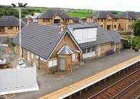 The station building on the westbound platform at Shotts on 23 September 2013, looking much improved since my last visit in 2006 [see image 41718]. From a distance I almost mistook it for one of the new houses being built in the background.<br><br>[John Furnevel 23/09/2013]