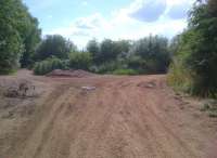 Most ironstone mines in the Midlands were opencast, but the line to the right from this junction - recently cleared to allow electric cable replacement - led to an underground mine opened as a quarry by the Ebbw Vale Steel Iron and Coal Co. in 1915, then converted to a mine in 1918. Ore was also supplied to the Scunthorpe works before closure in 1965. The mine had a 3 foot gauge electric railway, but was connected in 1938 to the Finedon quarries, which had a 2 foot gauge steam line. The line on the left is the LNWR from Peterborough to Northampton [see image 44129].<br><br>[Ken Strachan 26/07/2013]