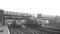 Holbeck Peak D53 <I>Royal Tank Regiment</I> struggles away from Carlisle with the 10.25am Leeds City - Glasgow Central on 6 December 1968. The train waiting at platform 7 is the 1pm service to Edinburgh Waverley via Hawick, with D5338 in charge.<br><br>[K A Gray 06/12/1968]