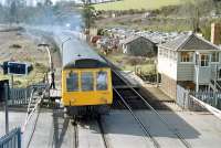 An Exeter - Barnstaple DMU runs over the level crossing at Crediton in 1984.<br><br>[Ian Dinmore //1984]