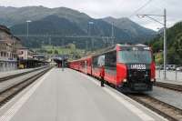 The Rhaetian Ge 4/4 III fleet are handsome and powerful (4160hp) locos that wouldn't look out of place on the standard gauge network. All twelve are in different advertising liveries but that on 648 <I>Susch</I> particularly complements the red coaching stock. The guard and driver of a Davos to Landquart service chat at Klosters while waiting for departure time.<br><br>[Mark Bartlett 15/09/2013]