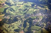 Aerial view over the triangle formed by Smyllum East, West and South junctions on the outskirts of Lanark, in 1999. The view is south, with Lanark Loch on the left and part of the town itself to the right. <br><br>[Ewan Crawford //1999]