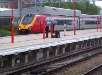 Surrounded by friends. The guard and two enthusiasts keep a Southbound Virgin Voyager company as it waits to depart from platform 6 at Stafford station on 2nd October.<br><br>[Ken Strachan 02/10/2013]