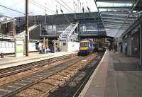 A Waverley bound service leaves Haymarket platform 3 on 9 August 2013.<br><br>[John Furnevel 09/08/2013]