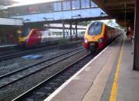 <I>'We don't often meet here, do we?'</I> Scene at Lancaster station on 29 July 2013. The Voyager on the right, the 19.47 to Birmingham, was on time; but the 19.07 to Glasgow (left) was distinctly late.<br><br>[Ken Strachan 29/07/2013]