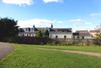 Some bushes seem to have been chopped since my last visit to the old Troon station,  allowing this full length, although not totally unobstructed, view of the up [Glasgow] buildings in October 2013.<br><br>[Colin Miller 10/10/2013]