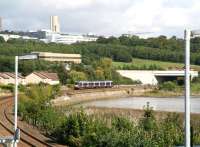 An early afternoon Dundee - Glasgow Queen Street service skirts the north shore of the Tay on the approach to Invergowrie. View east in September 2006, with Ninewells Hospital standing on the hillside in the background.<br><br>[John Furnevel 11/09/2006]