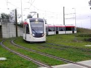 A tram rounds the sharp curve just west of the Gogarburn tram stop on 11 October 2013 on a test run between Edinburgh Airport and Gogar Depot.<br><br>[Alasdair Taylor 11/10/2013]