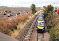 View north over the site of Edinburgh Gateway station on 14 October 2013 with 170401 passing.The new station is expected to open in 2016. Edinburgh Airport tower stands in the left background.<br><br>[Bill Roberton 14/10/2013]