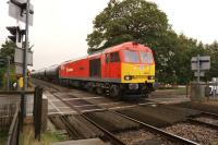 DBS 60019 hauls a long train of empty fuel tank wagons heading north to the Lindsey Oil Refinery over the level crossing at Moortown, Lincolnshire, on 9 October 2013.<br><br>[John McIntyre 09/10/2013]