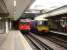 Hammersmith and City line unit 5553 runs into the west bound H&C platform at Paddington station on 9 August, passing First Great Western Turbo DMU 165129 stabled at main line platform 14. <br><br>[David Pesterfield 09/08/2013]